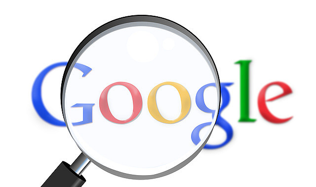 Magnifying glass looking at Google