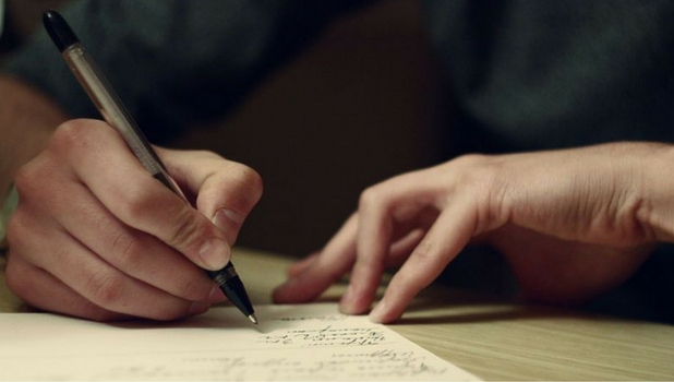 Person writing on paper