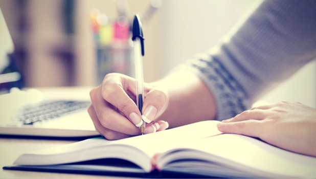 Woman writing in note book