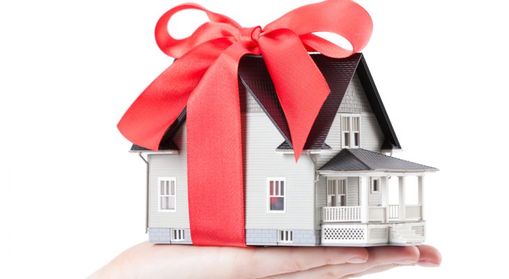 Model house wrapped in a red bow